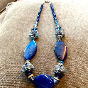 Blue beaded costume;large navy stones, smaller navy beads,light blue clusters